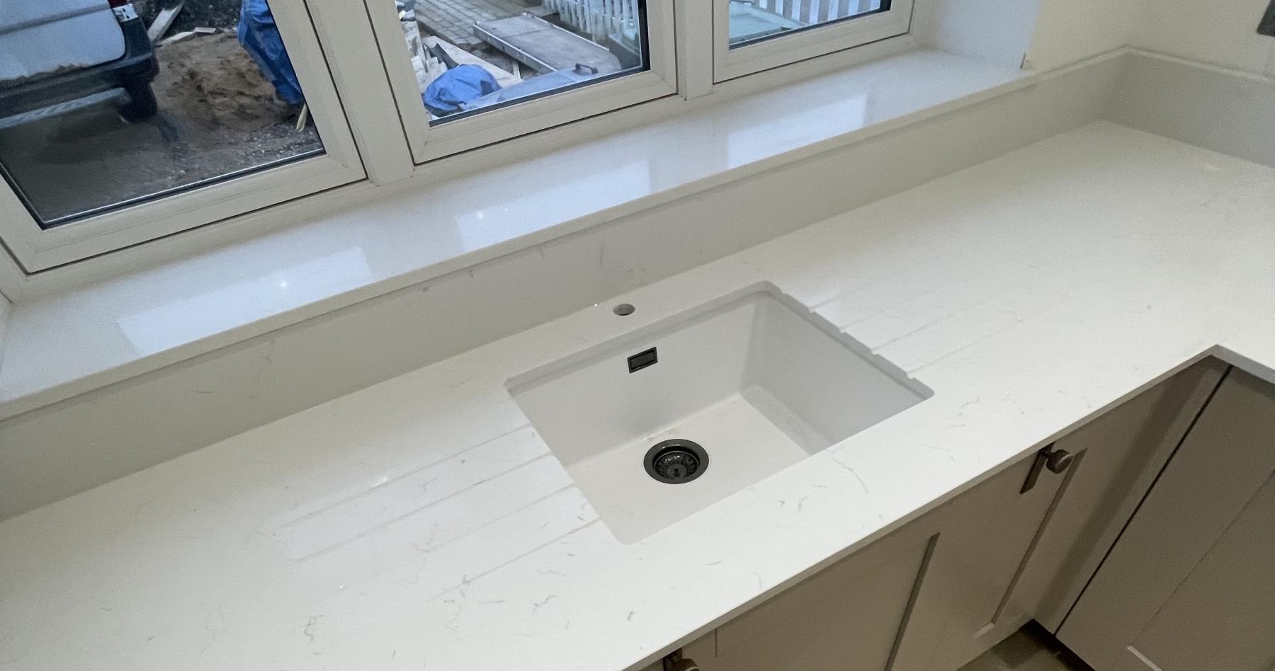 Carrara Shimmer undermounted sink with window sill. Project: Arlesey 