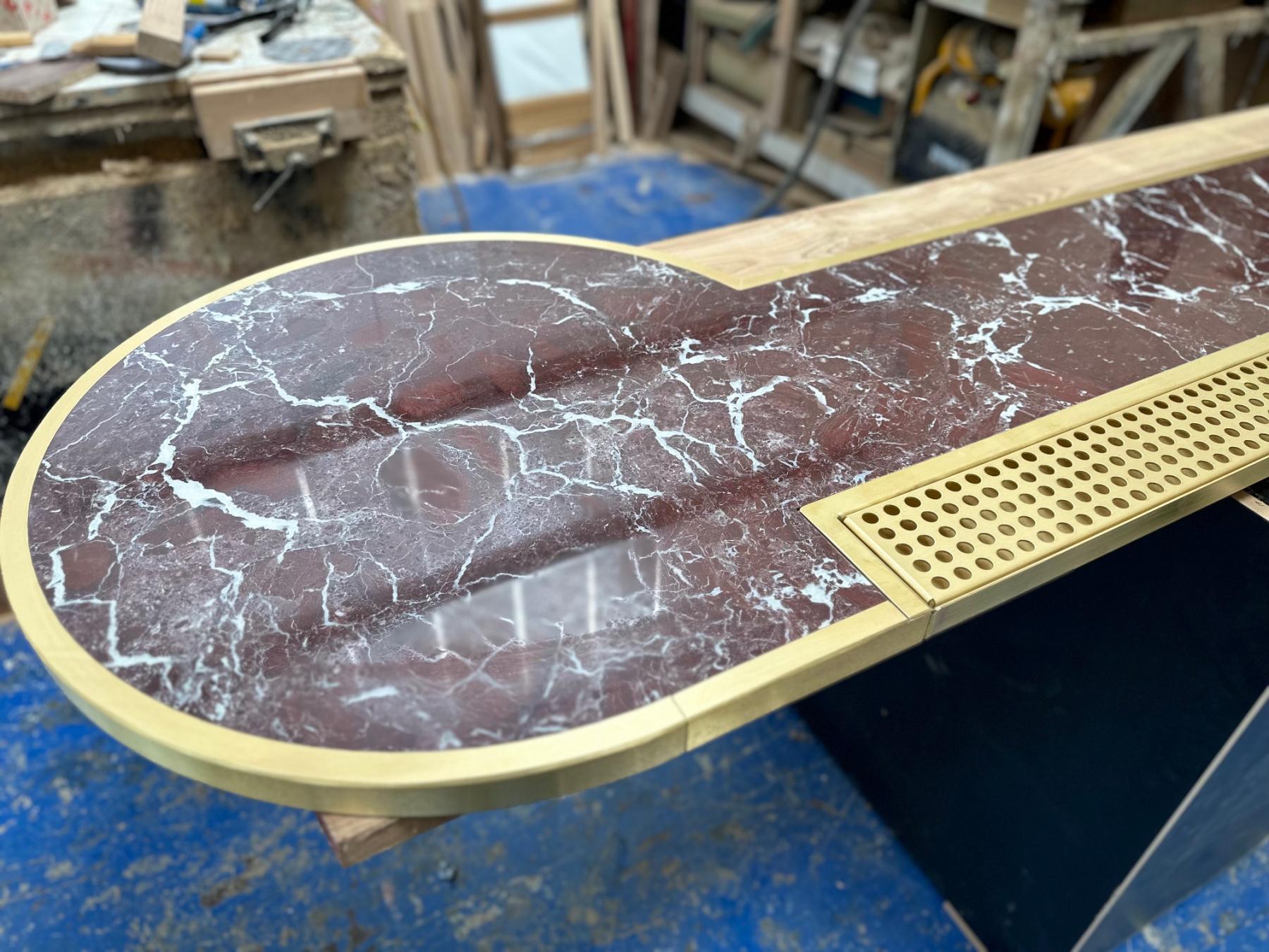 Rosso Levante marble bar inserted into brass 