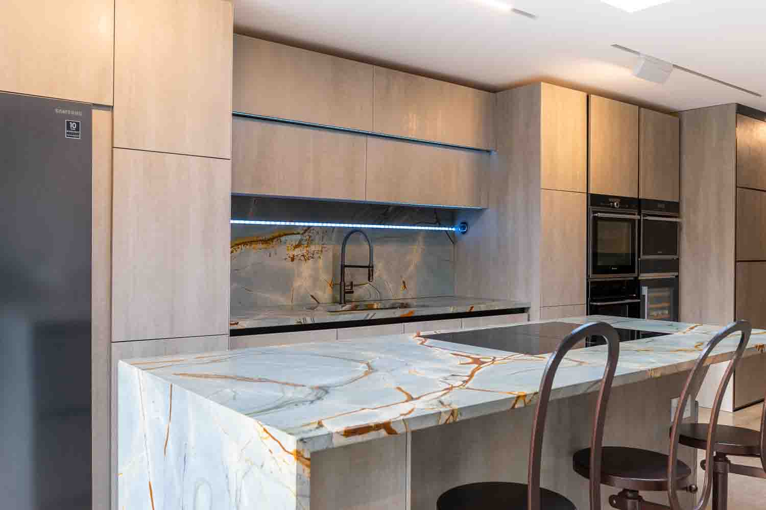 Project: HATFIELD. Blue Roma Island with mitred waterfall leather and polished